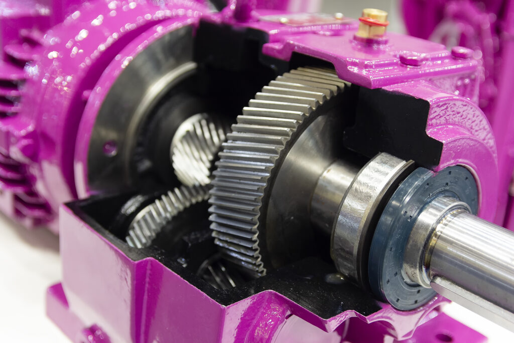 Gearbox on large electric motor at industrial equipment plant close-up. Industry