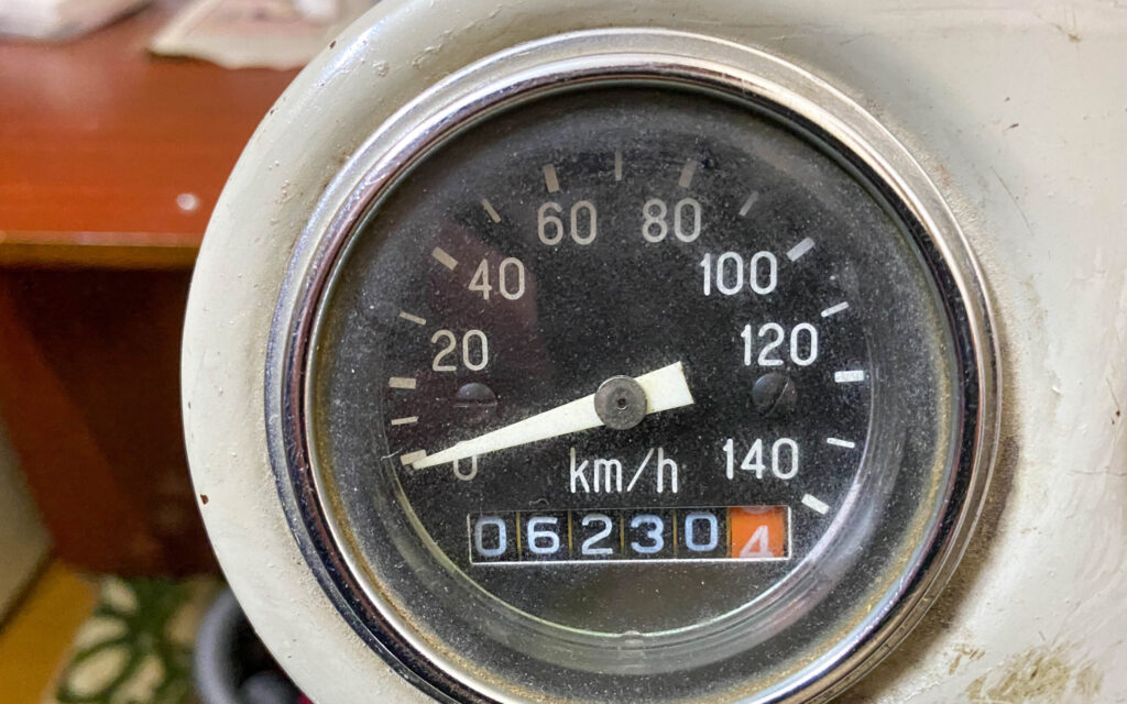 Old vintage retro round speedometer with sleeper in kilometers per hour. Riding speed measuring device.