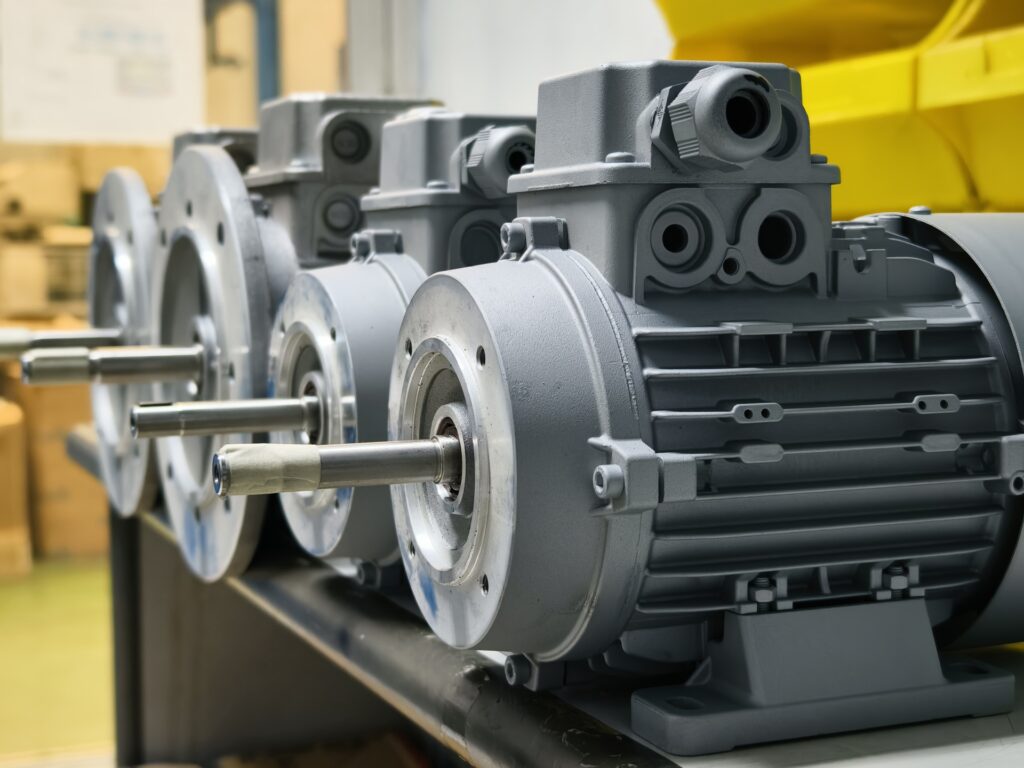 Close-up view of multiple new electric motors neatly arranged in a factory environment ready for use.